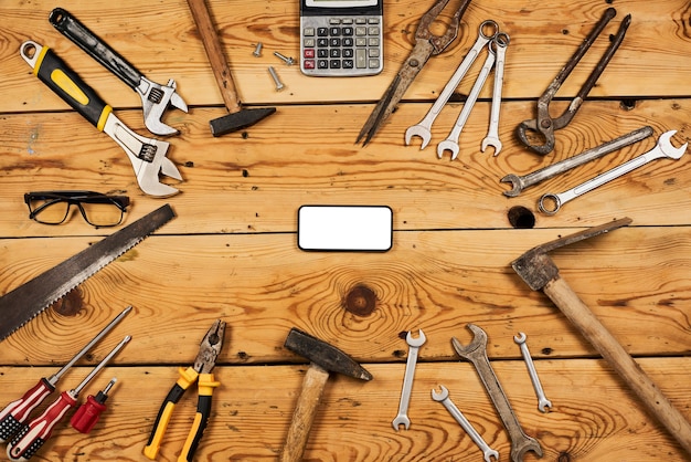 Frame of handy tools on wooden board