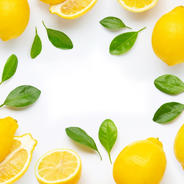 Frame made of fresh lemon and  slices with leaves isolated on white