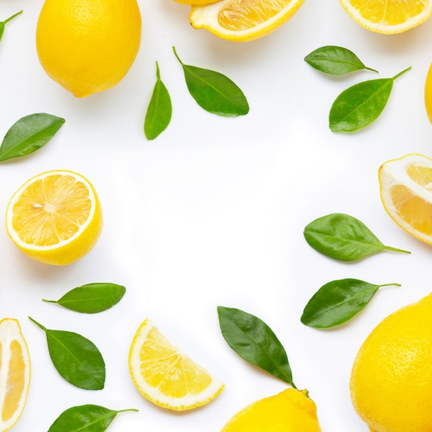 Frame made of fresh lemon and  slices with leaves isolated on white