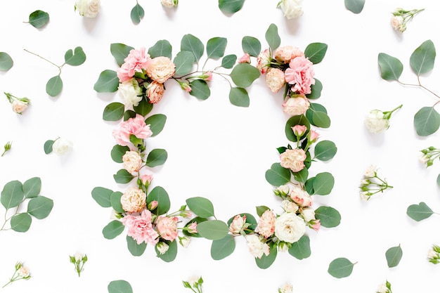 Frame made of roses and cloves green leaves eucalyptus branches floral pattern on white background f