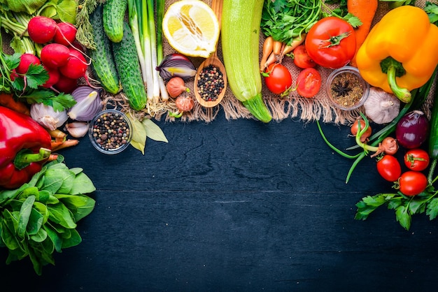 Frame of organic food Fresh raw vegetables and spices On a wooden chalkboard