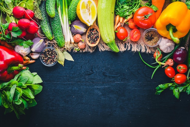 Frame of organic food Fresh raw vegetables and spices On a wooden chalkboard