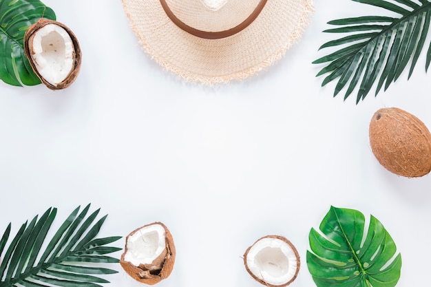 Frame of palm leaves, coconuts and straw hat