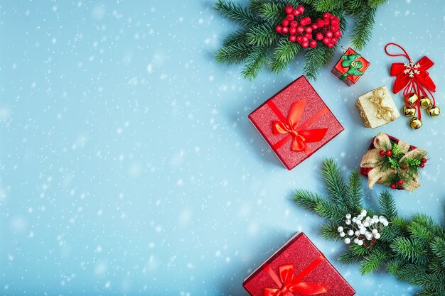 Frame of twigs christmas tree, brown natural pine cones and red berries on snow with space for text. Top view, flat lay