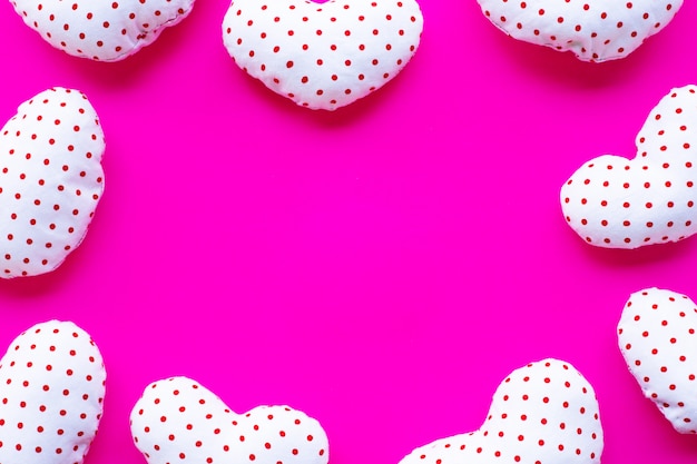 Frame of valentine's hearts on pink background.