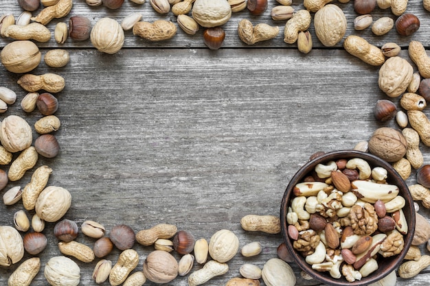 Frame of various nuts on rustic wooden table