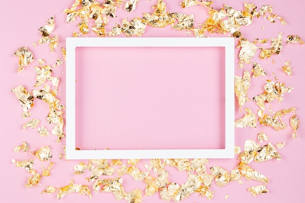 Frame with golden shimmer glitter over the pink pastel wall.  Copy space