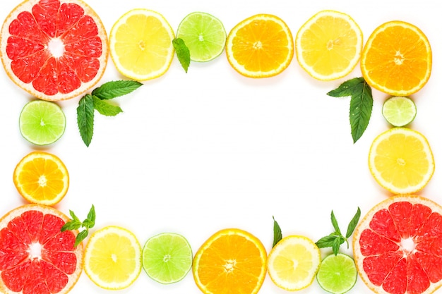 Frame with slice of oranges, lemons, limes, grapefruit and mint pattern on white