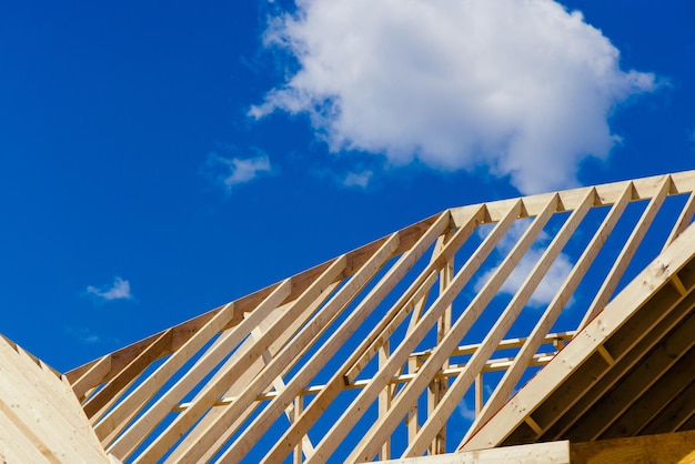 Framework of beam framing unfinished roofing for new home with wooden truss