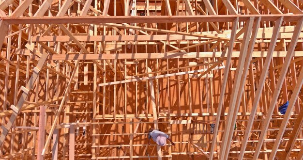 Framing beam of new house under construction top view with wooden roof frame