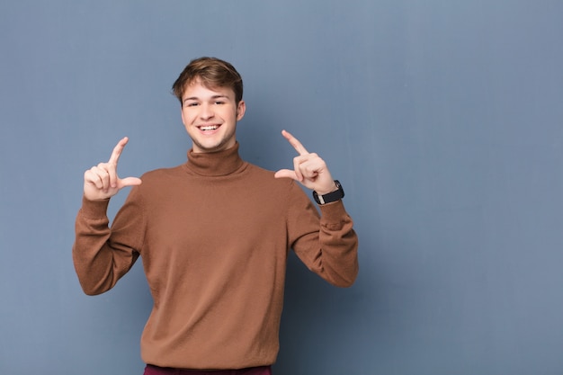 framing or outlining own smile with both hands, looking positive and happy, wellness concept