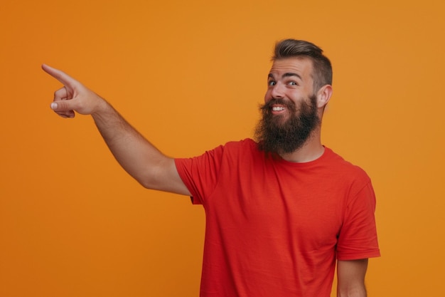 Free photo indoor shot of positive person in casual red tshirt points with index finger aside