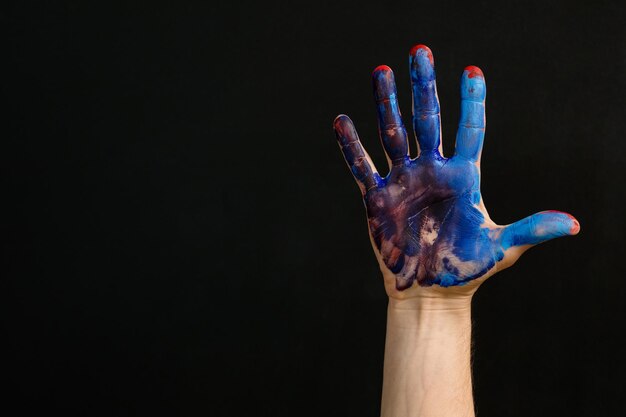 Freedom creativity choice Hand smeared with red blue paint Palm raised to express individuality Art lifestyle imagination