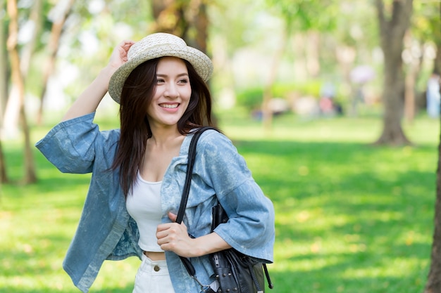 Freedom and Finding Concept: Casual cute smart Asian women walking in the park in summer