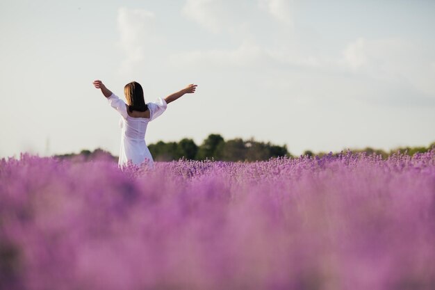 Freedom woman with hands up in lavender fields