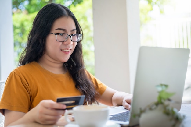 Freelance  business female casual show holding a credit card working with laptop