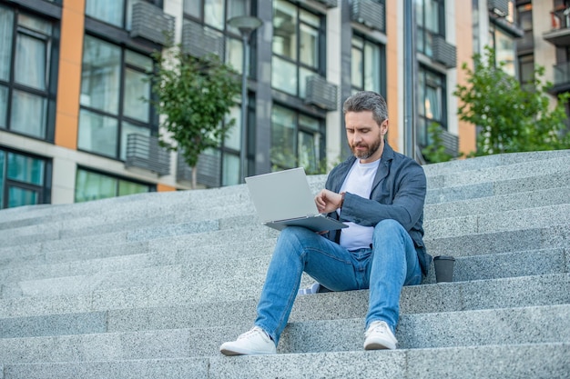 Freelance man in the street with copy space freelance man with pc outside