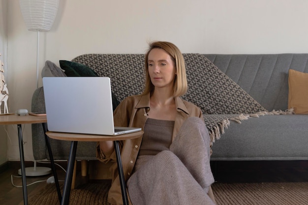 Freelancer woman working and relaxing at home in living room