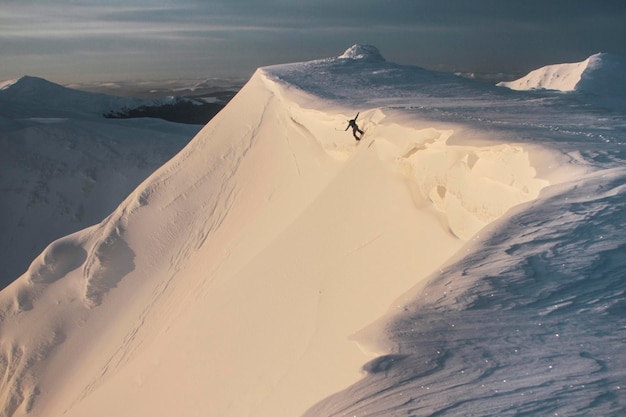 Freeride in morning mountains winter freeride extreme sport man snowboarding downhill