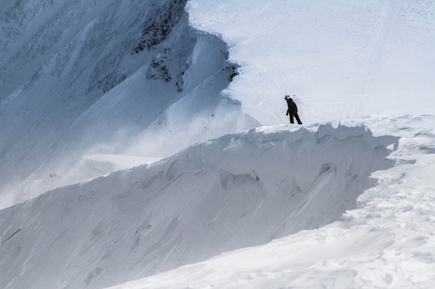 Freerider prepares to descend from snowcovered mountain