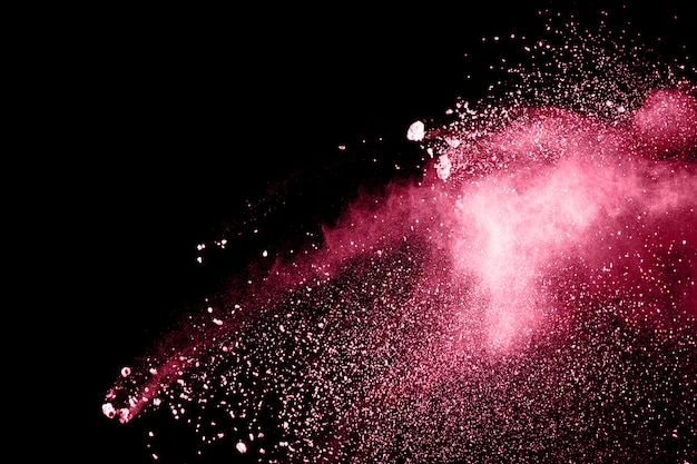 Freeze motion of red dust particles splashing.