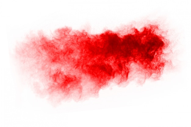 Freeze motion of red powder exploding, isolated on white background.  