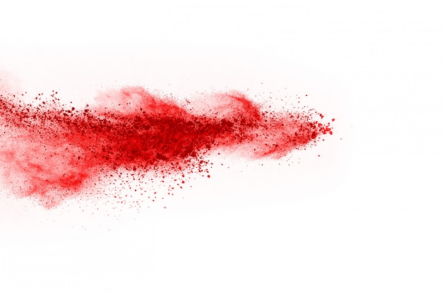 Freeze motion of red powder exploding, isolated on white background.  