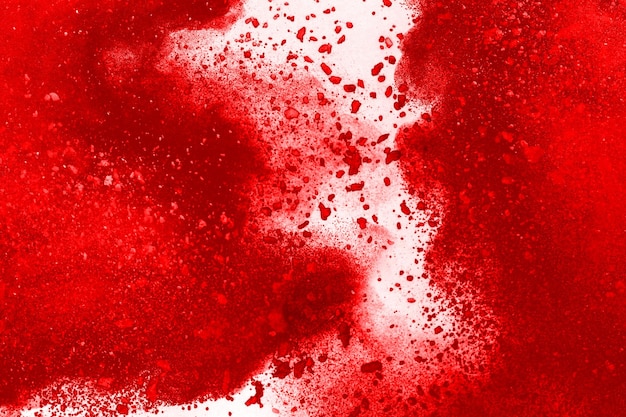 Freeze motion of red powder exploding isolated on white background