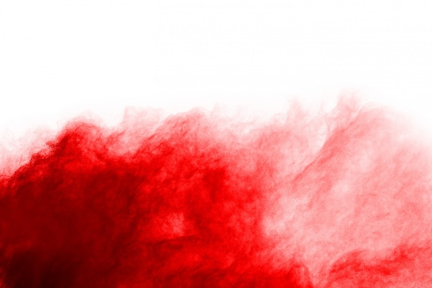 Freeze motion of red powder exploding, isolated on white background.  