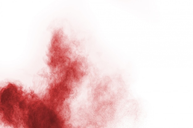 Freeze motion of red powder exploding, isolated on white background. 