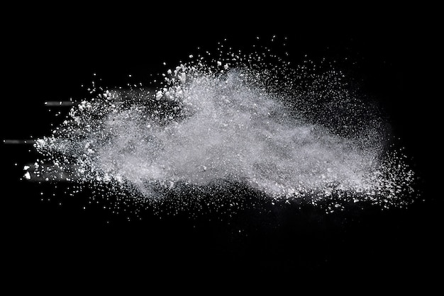 Freeze motion of white powder explosions isolated on black background.