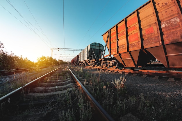 Freight train in the background of sunset - dawn is waiting for departure to its destination