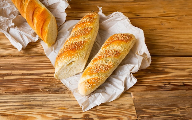 French baguette on white wooden background