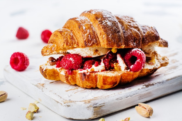 French croissants with cream cheese and raspberry