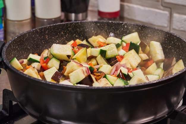 French cuisine ratatouille salad in frying pan on gas stove