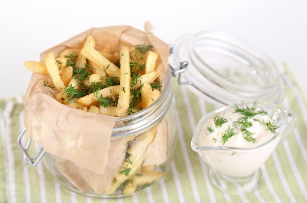 French fries in bank on napkin isolated on white