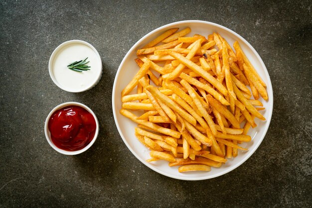 French fries or potato chips with sour cream and ketchup