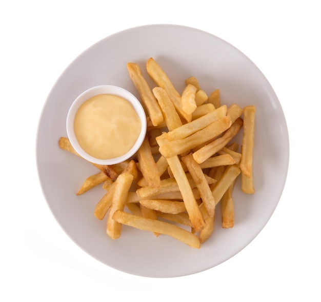 French fries potatoes with mayonnaise on a dish isolated on white background