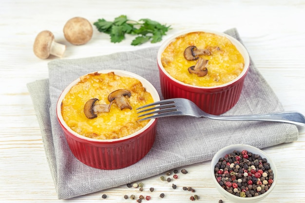 French Julienne casserole with chicken and mushroom in portion ramekin on white background