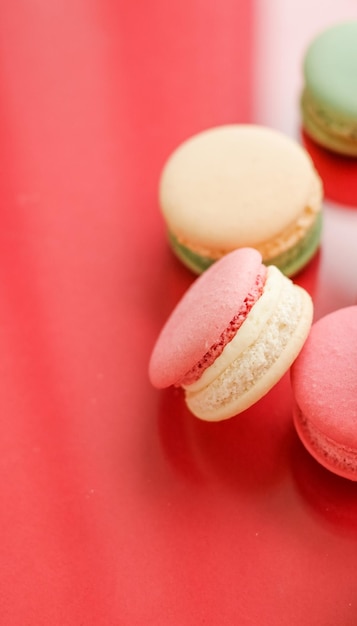 French macaroons on red background parisian chic cafe dessert sweet food and cake macaron for luxury confectionery brand holiday backdrop design