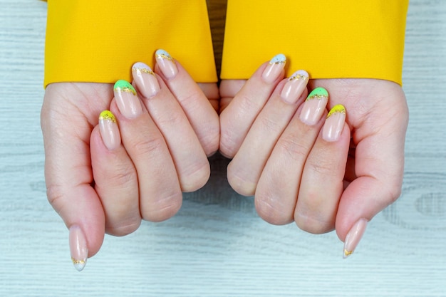 French manicure in green yellow purple on a solid background Nail art on women's nails Women's