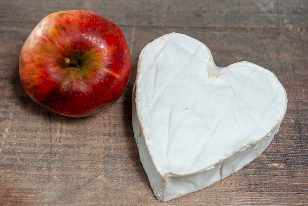 French Neufchatel cheese shaped heart with an organic apple