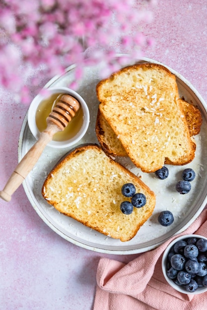 French toast drizzled with honey and coconut flakes and blueberry  Breakfast concept