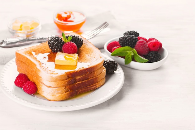 French toast with honey, butter and fresh berries