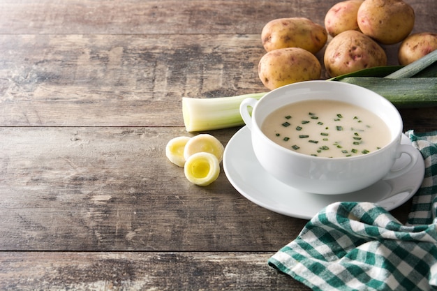 French vichyssoise soup in bowl on wooden table. Copyspace