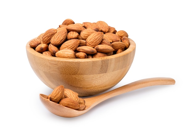 Fresh almonds nut in wooden bowl with spoon.