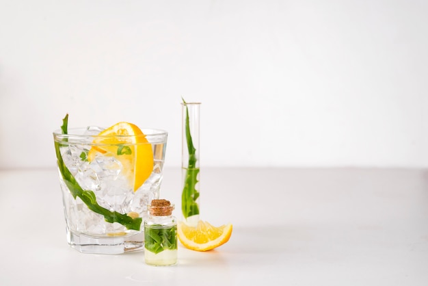 Fresh aloe vera leaves and aloe vera juice in glass on white background