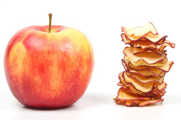 Fresh Apple and a stack of dried Apple slices on white background. vitamin fruit food