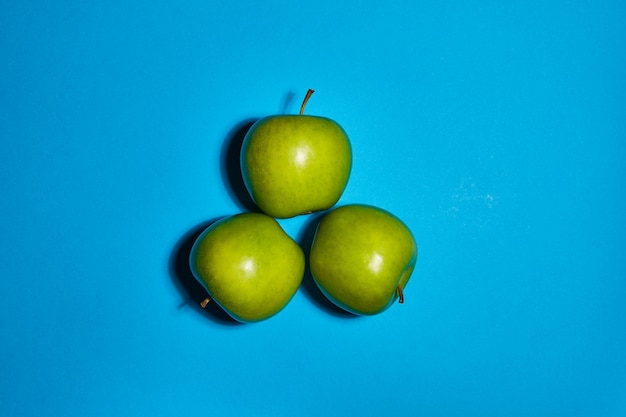 Fresh apples on blue background