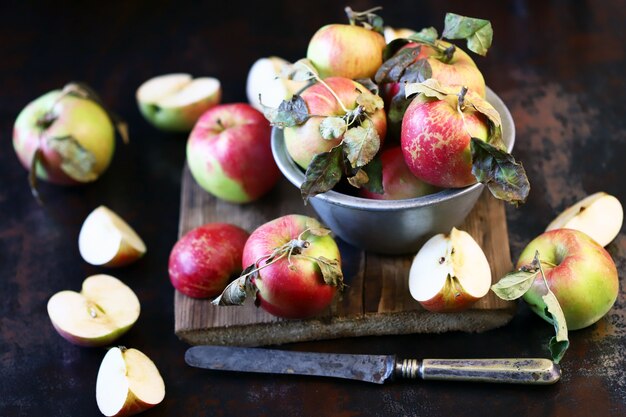 Fresh apples in a bowl on a wooden surface